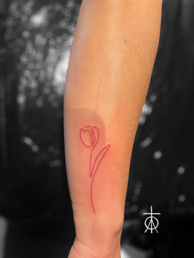 Red Ink Fine Line Tulip Tattoo by The Best Fine Line Tattoo Artist Claudia Fedorovici